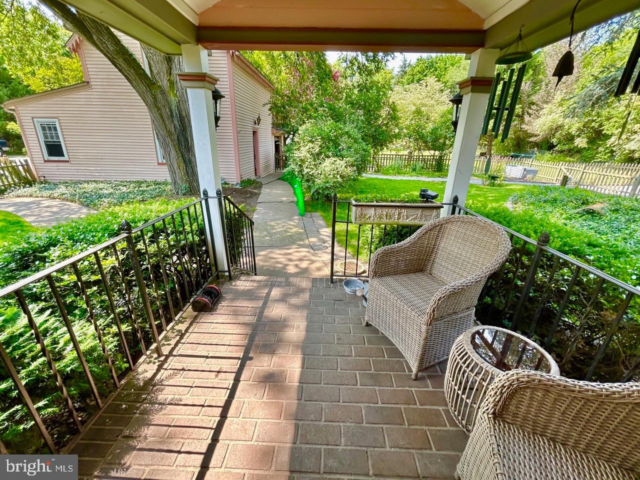 9087 Highland Street Mauricetown, NJ 08329 - Photo 17 of 48 a view of a patio with couches chairs potted plants and floor to ceiling window
