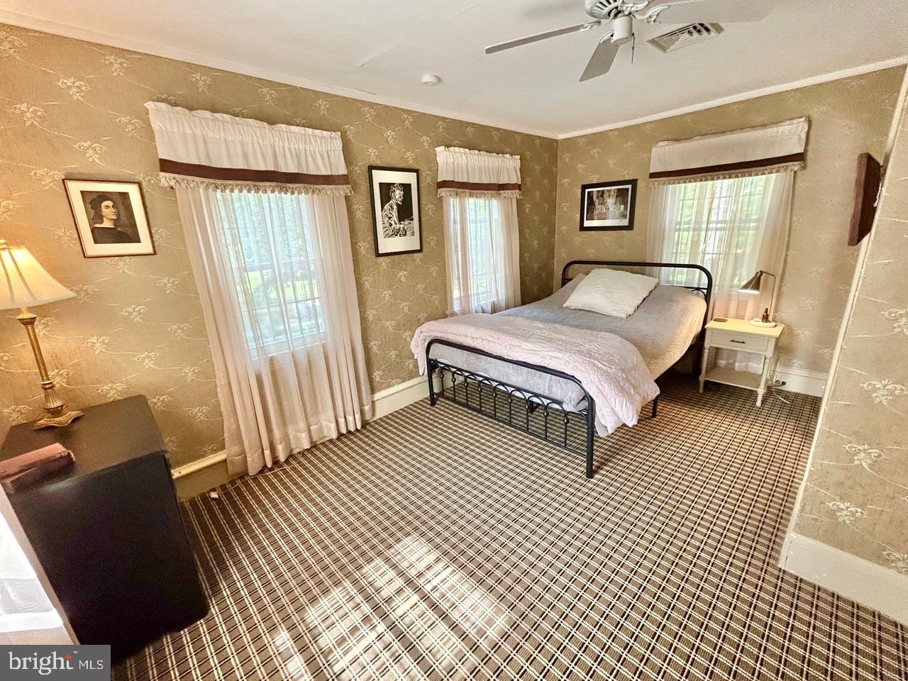 9087 Highland Street Mauricetown, NJ 08329 - Photo 20 of 48 a spacious bedroom with a bed lamp and a dresser