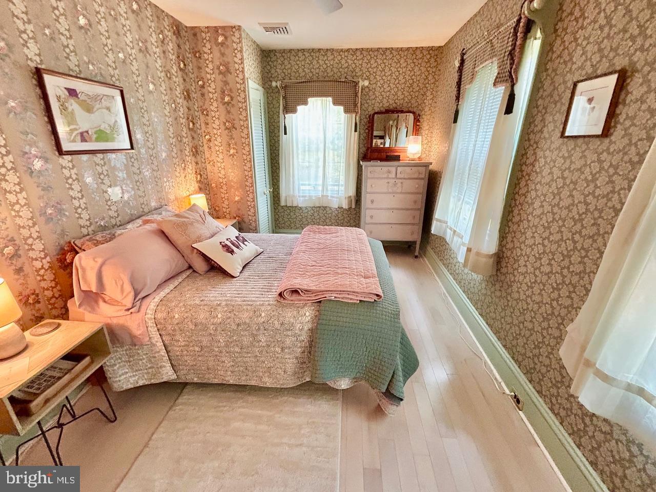 9087 Highland Street Mauricetown, NJ 08329 - Photo 22 of 48 a bedroom with a bed and a large mirror on the dresser