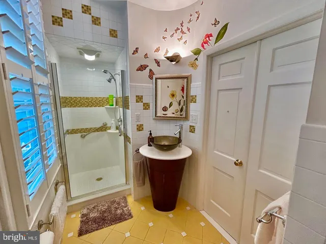 a bathroom with a sink a mirror and shower