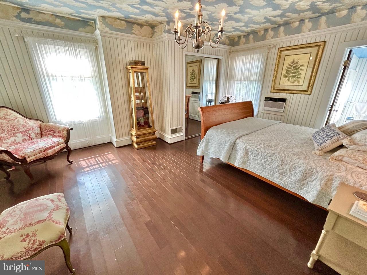 9087 Highland Street Mauricetown, NJ 08329 - Photo 25 of 48 a bedroom with a bed and wooden floor