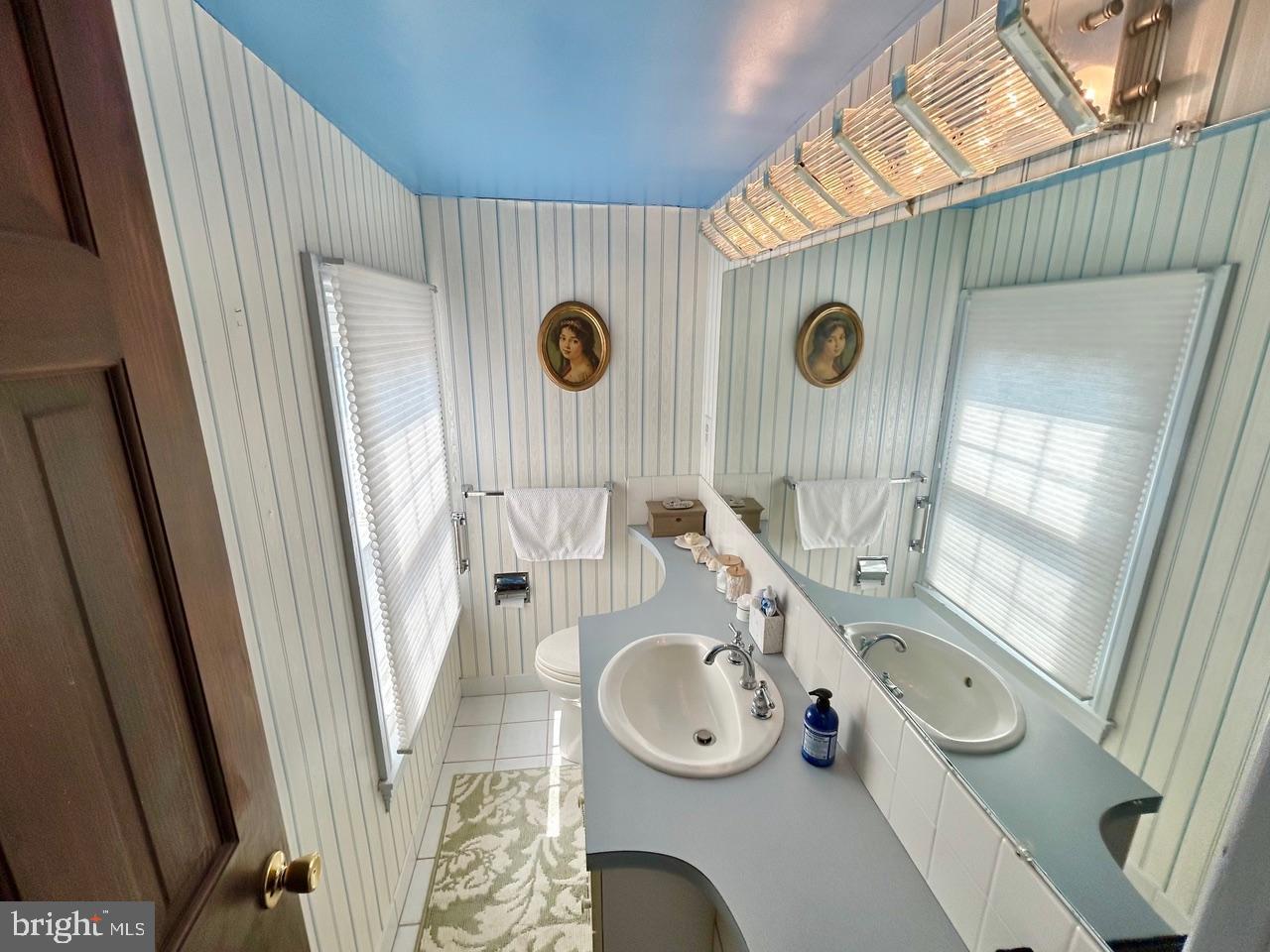 9087 Highland Street Mauricetown, NJ 08329 - Photo 27 of 48 a bathroom with a sink a mirror and shower