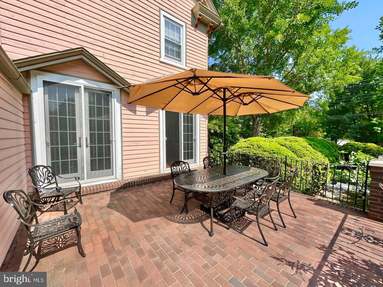 9087 Highland Street Mauricetown, NJ 08329 - Photo 31 of 48 a patio with a table and chairs under an umbrella