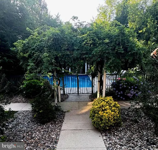 a front view of a house with a yard and potted plants