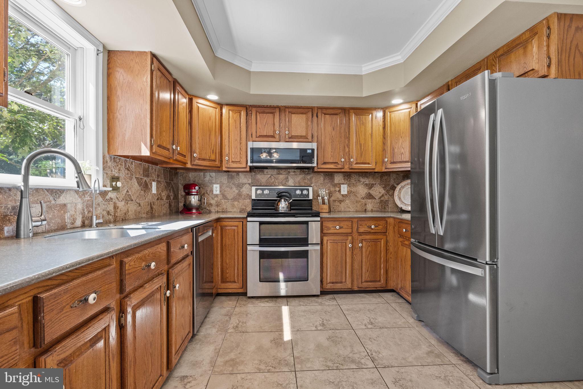 275 West Sandy Ridge Road Doylestown, PA 18901 - Photo 11 of 54 a kitchen with stainless steel appliances granite countertop a refrigerator oven a sink dishwasher and a stove