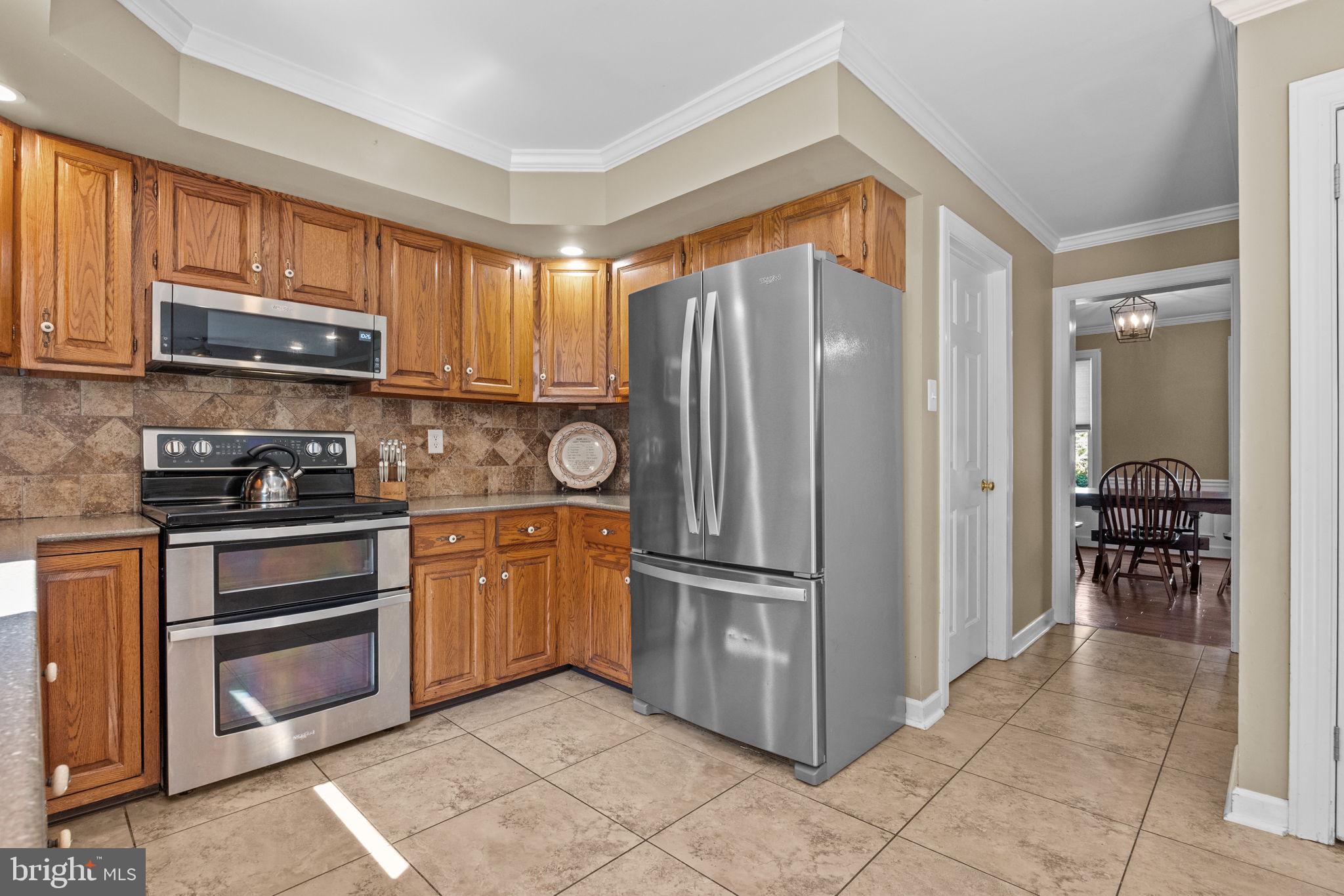 275 West Sandy Ridge Road Doylestown, PA 18901 - Photo 13 of 54 a kitchen with stainless steel appliances granite countertop a refrigerator and a stove top oven