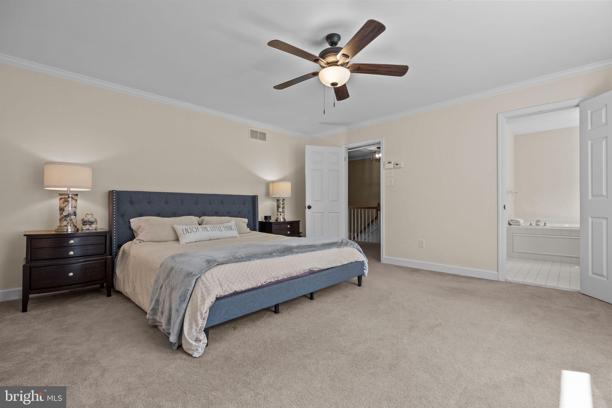 275 West Sandy Ridge Road Doylestown, PA 18901 - Photo 23 of 54 a spacious bedroom with a bed and a chandelier