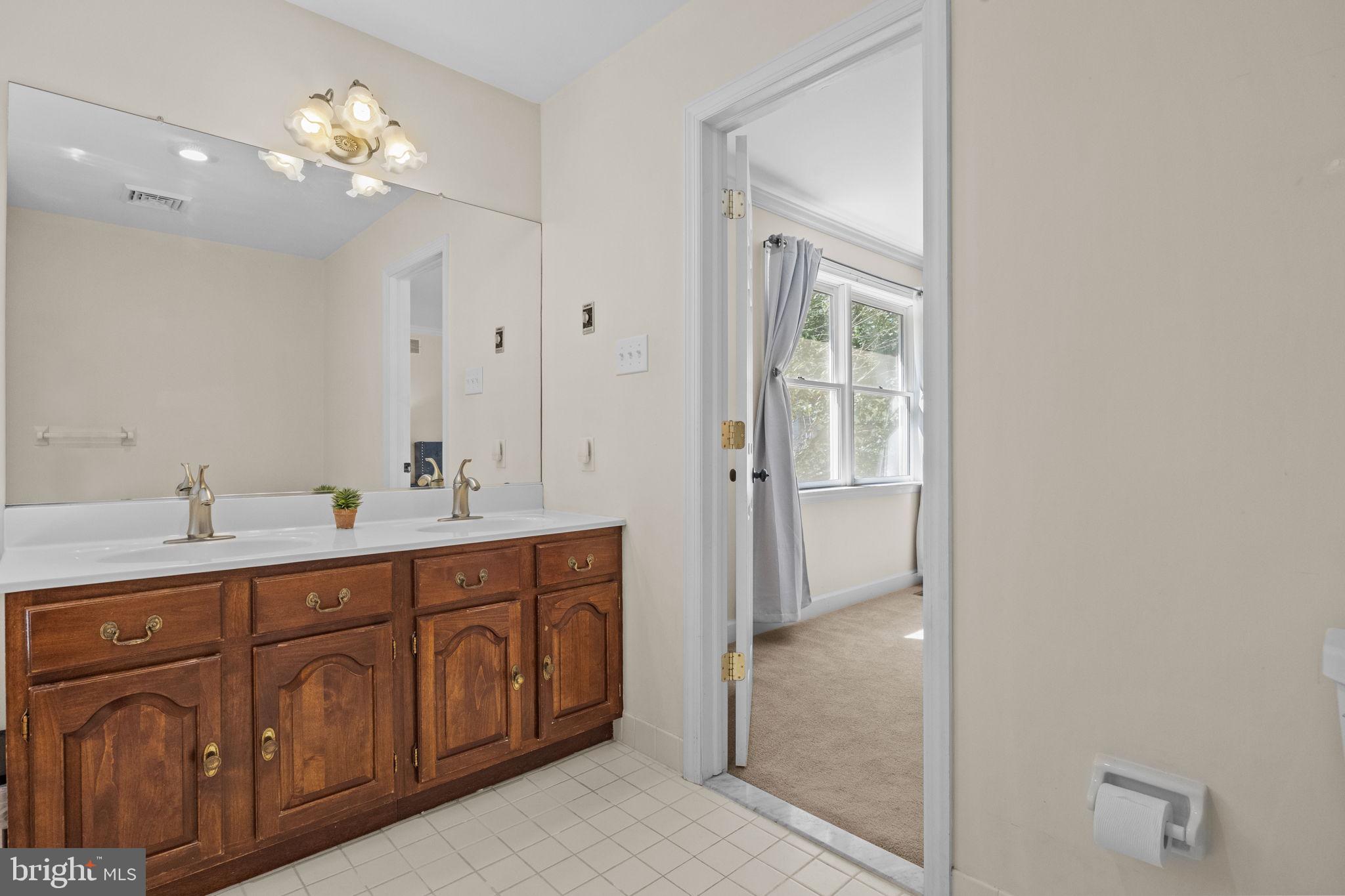 275 West Sandy Ridge Road Doylestown, PA 18901 - Photo 26 of 54 a spacious bathroom with a double vanity sink a large mirror and a shower