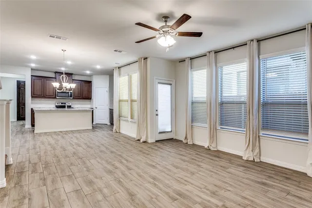 a view of a livingroom with kitchen appliances and cabinets