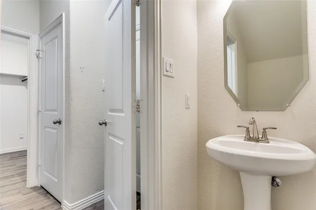 a bathroom with a sink and mirror