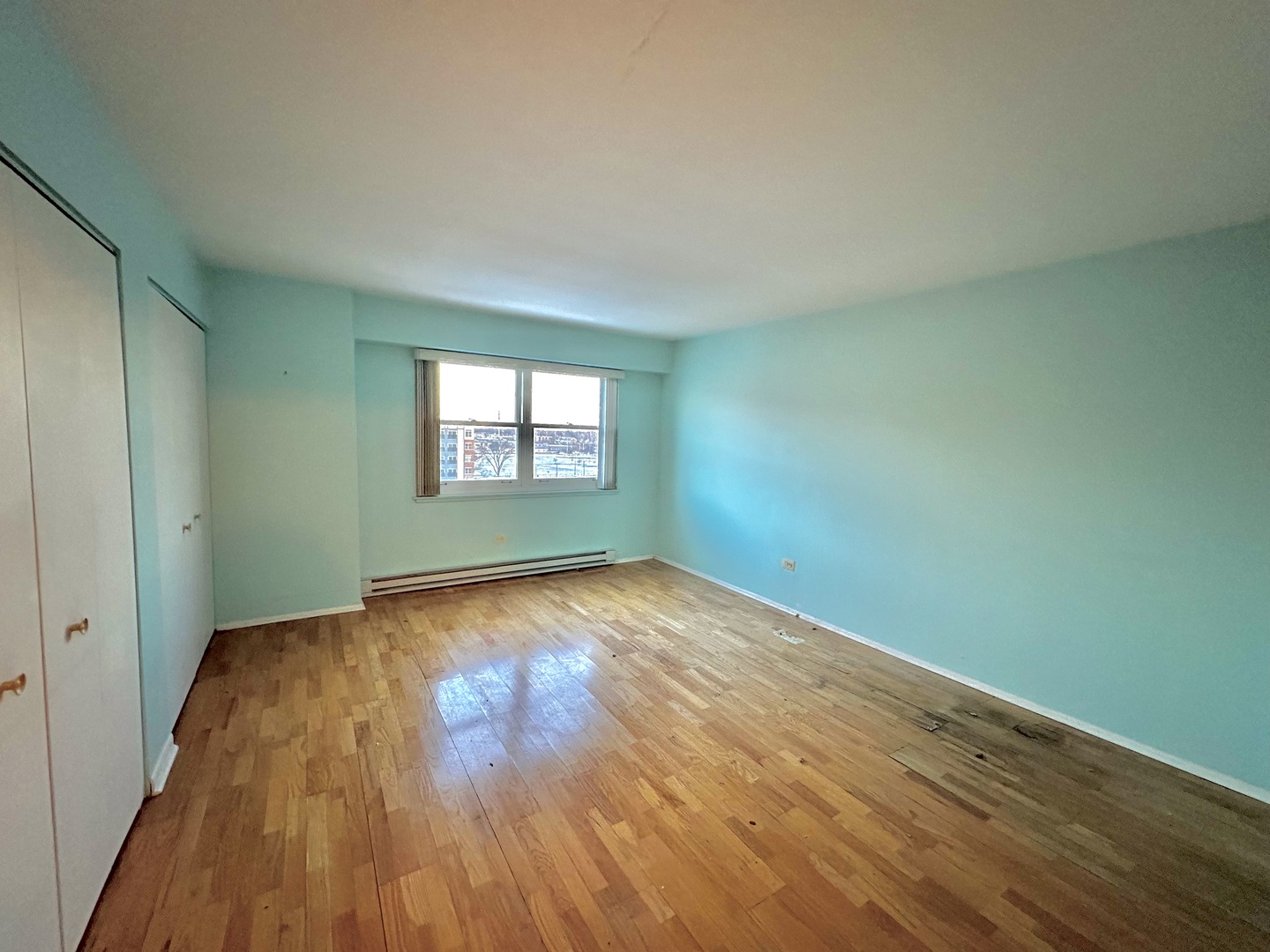 141 North La Grange Road, Unit 602 La Grange, IL 60525 - Photo 11 of 16 an empty room with wooden floor and windows