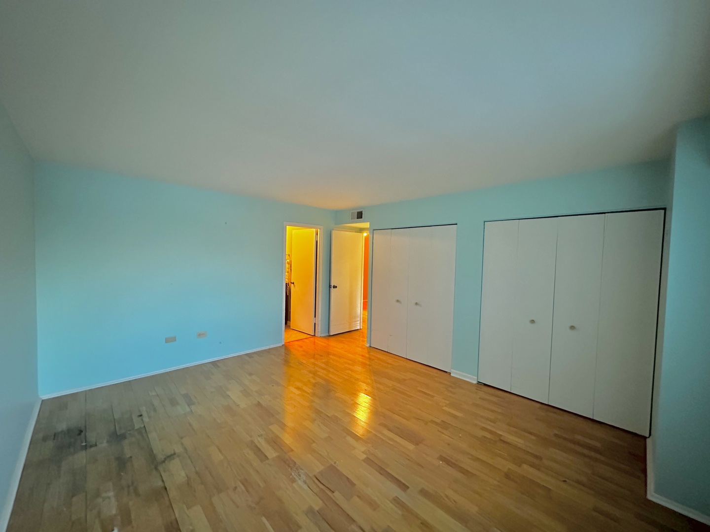 141 North La Grange Road, Unit 602 La Grange, IL 60525 - Photo 12 of 16 a view of an empty room with wooden floor and a window