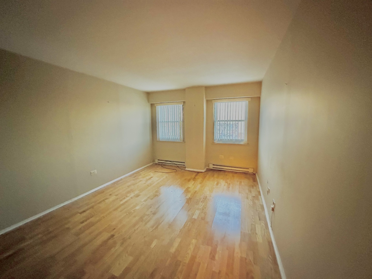 141 North La Grange Road, Unit 602 La Grange, IL 60525 - Photo 7 of 16 an empty room with wooden floor and windows