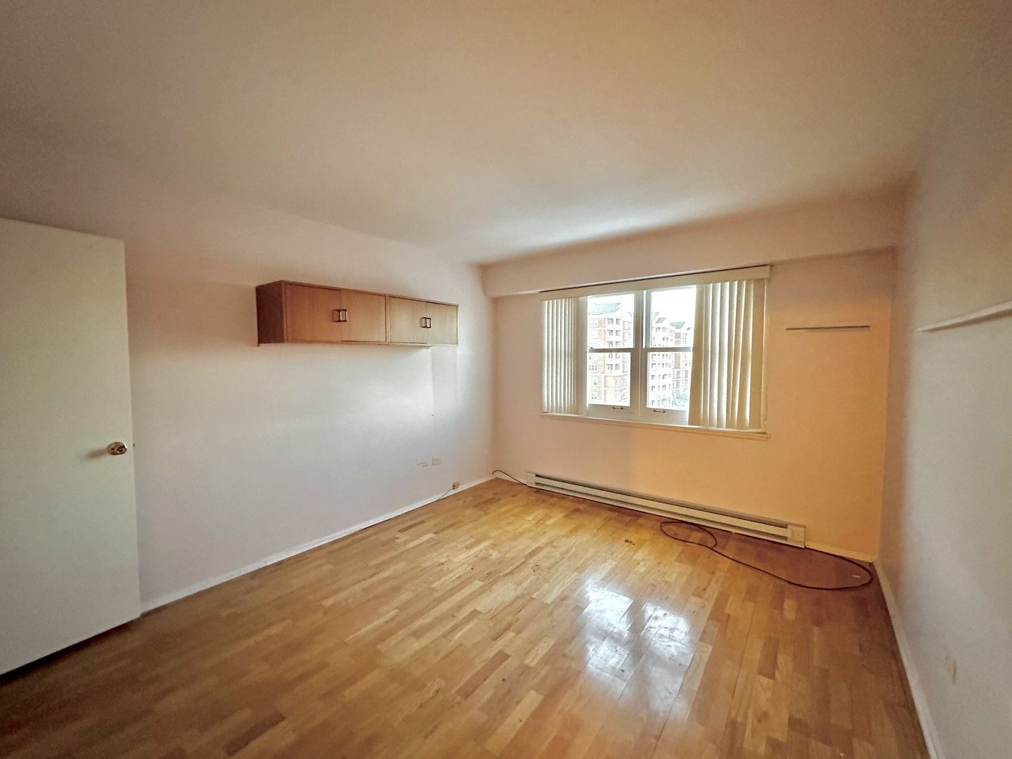 141 North La Grange Road, Unit 602 La Grange, IL 60525 - Photo 9 of 16 a view of an empty room with wooden floor and a window