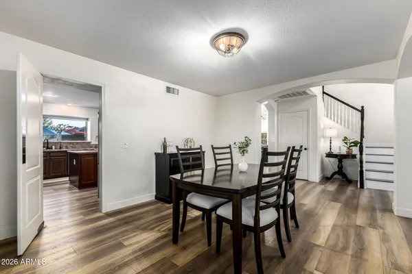 a view of a dining room with furniture and wooden floor