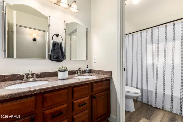 a bathroom with a double vanity sink and a mirror