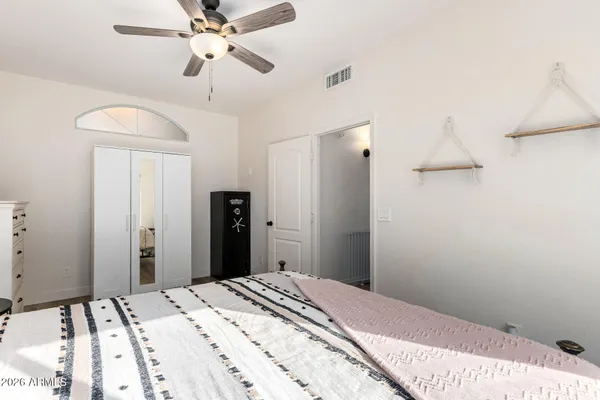a bedroom with a bed and a chandelier