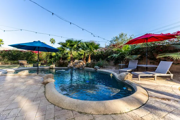 a view of a swimming pool with sitting area