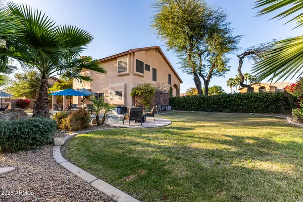 a view of a house with pool and a yard