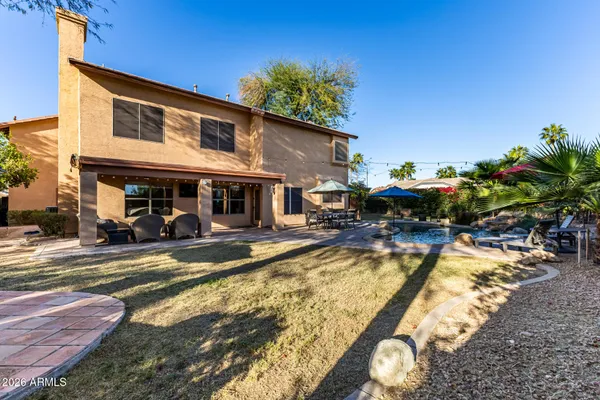 a view of a house with swimming pool and sitting area