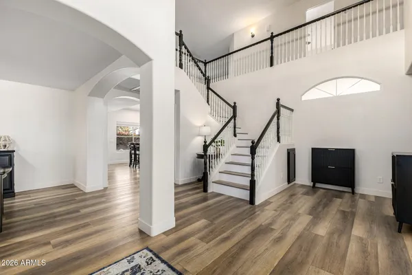 a view of entryway and hall with wooden floor