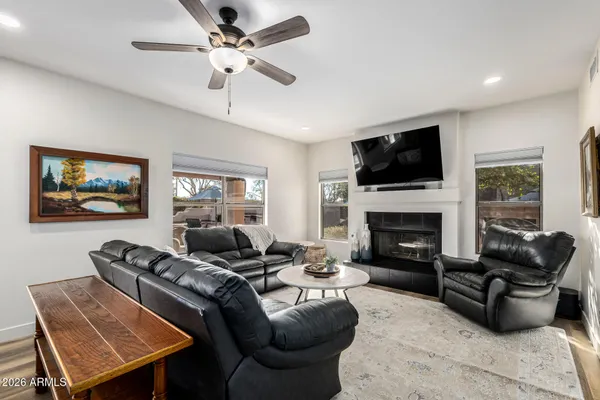 a living room with furniture fireplace and a flat screen tv