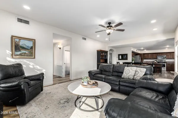 a living room with furniture and a view of kitchen