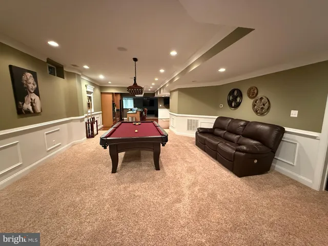 a living room with furniture and a gym equipment with wooden floor