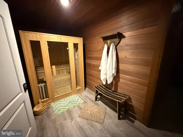 a view of a room with wooden floor and windows