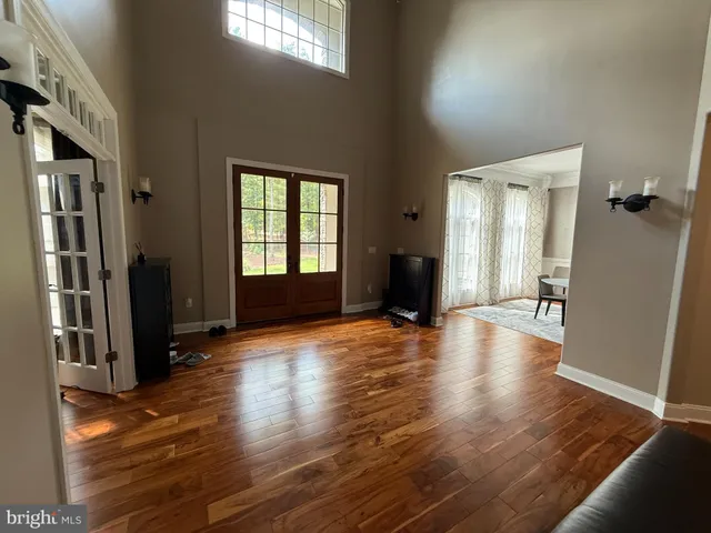 an empty room with wooden floor and a window