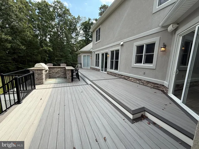 a balcony with wooden floor and outdoor space