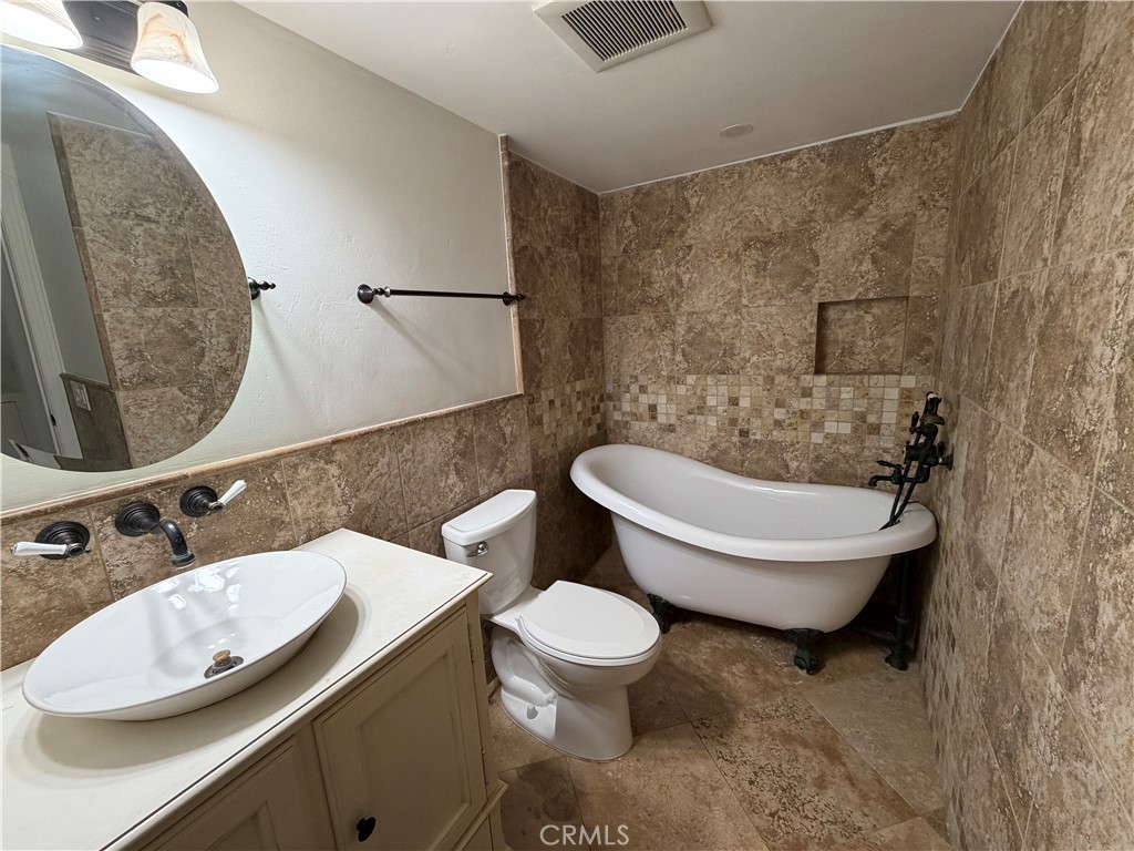 34132 Selva Road, Unit 250 Dana Point, CA 92629 - Photo 11 of 25 a bathroom with a toilet sink and mirror