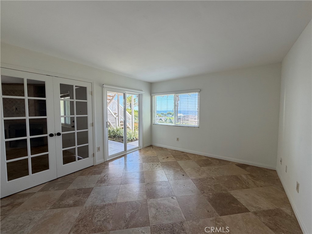 34132 Selva Road, Unit 250 Dana Point, CA 92629 - Photo 14 of 25 an empty room with windows and cabinet