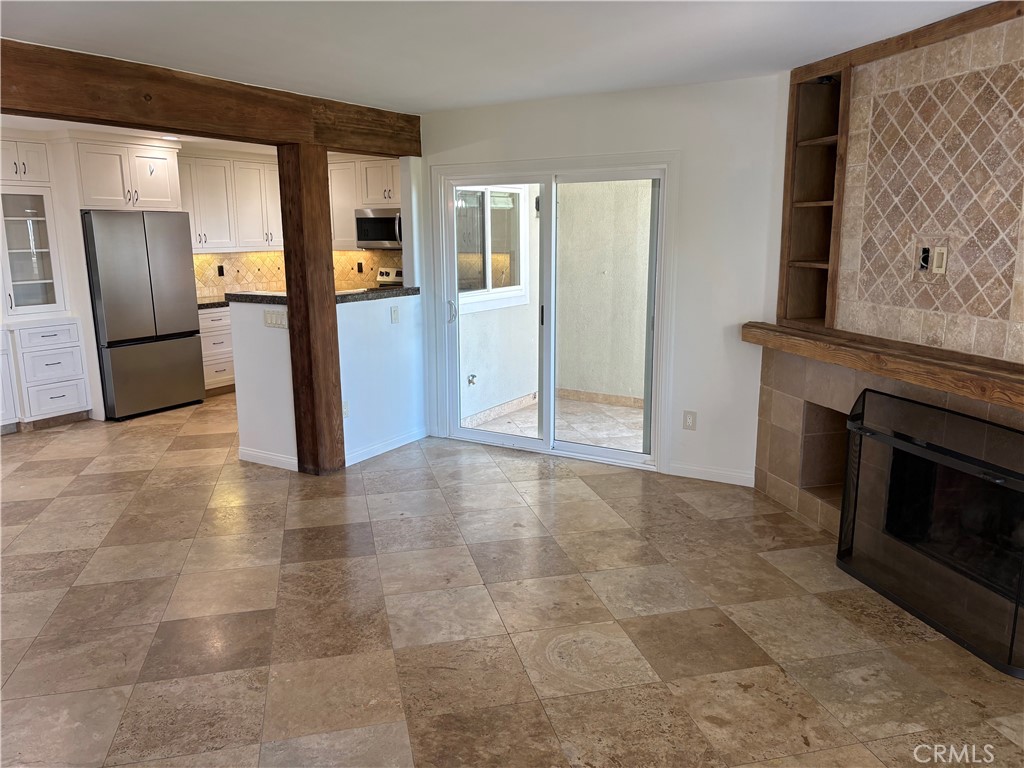 34132 Selva Road, Unit 250 Dana Point, CA 92629 - Photo 6 of 25 a view of a kitchen with an empty room and fire place