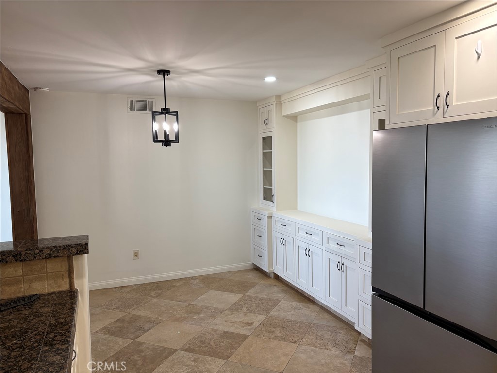 34132 Selva Road, Unit 250 Dana Point, CA 92629 - Photo 7 of 25 a view of an empty room with a fireplace