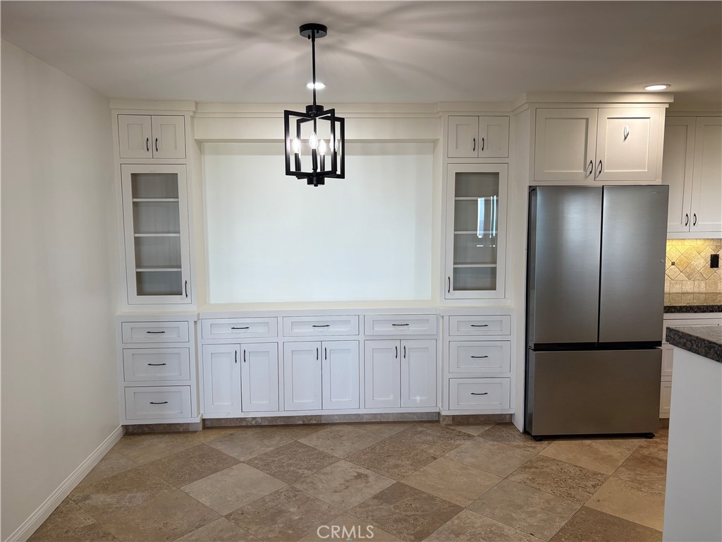34132 Selva Road, Unit 250 Dana Point, CA 92629 - Photo 8 of 25 a view of a kitchen with white cabinets and stainless steel appliances
