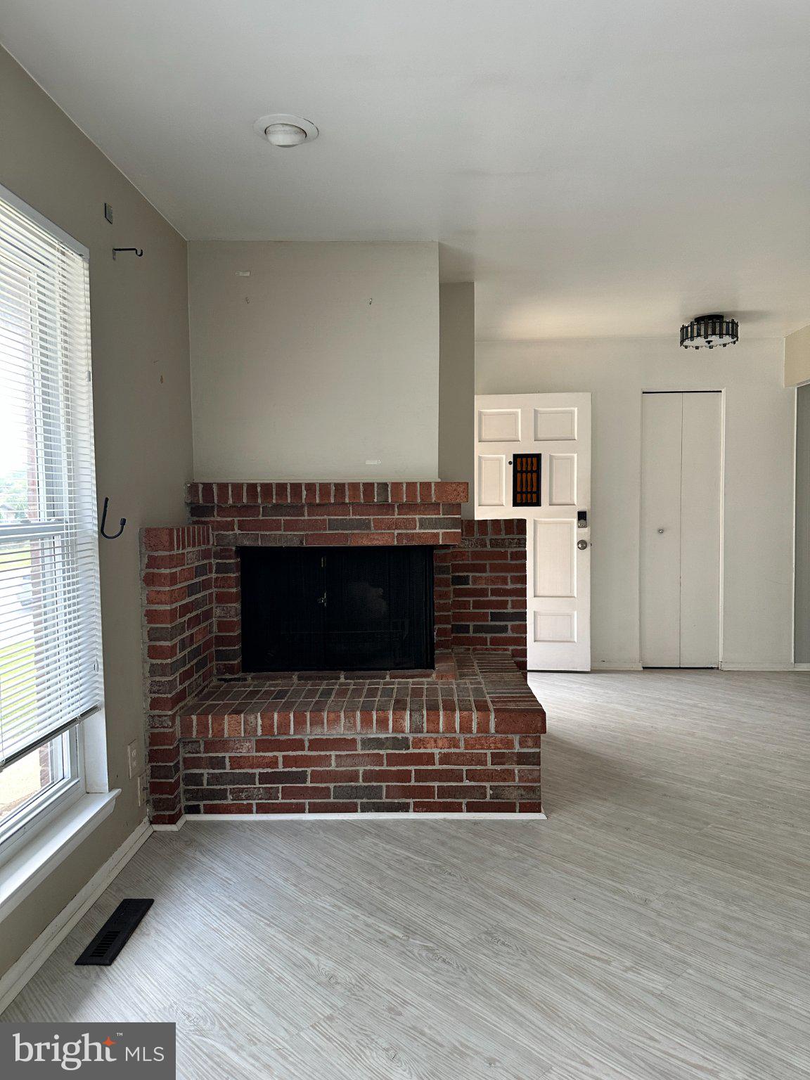 8336 Scotts Level Road Baltimore, MD 21208 - Photo 7 of 55 Cozy living space with brick fireplace.