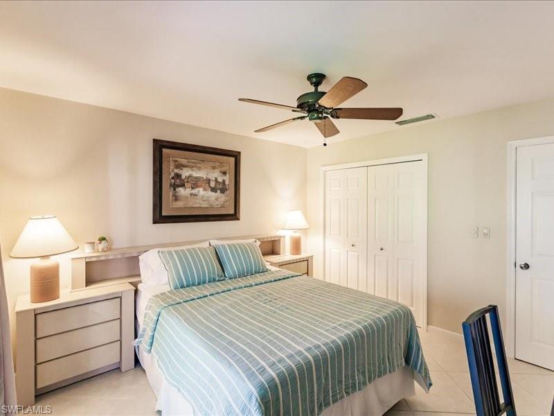 910 Vanderbilt Beach Road, Unit 524W Naples, FL 34108 - Photo 28 of 44 Tiled bedroom featuring ceiling fan and a closet