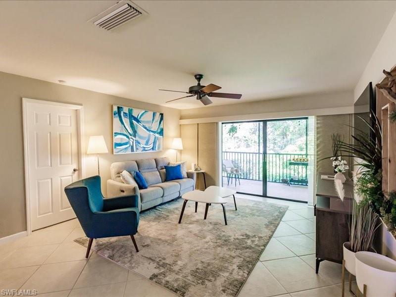 910 Vanderbilt Beach Road, Unit 524W Naples, FL 34108 - Photo 4 of 44 Living room with ceiling fan and light tile flooring
