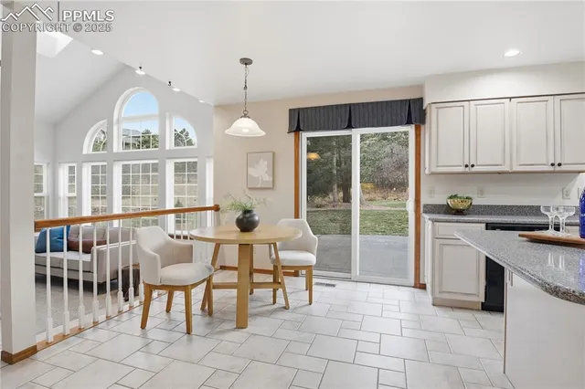 a view of kitchen with furniture and chandelier