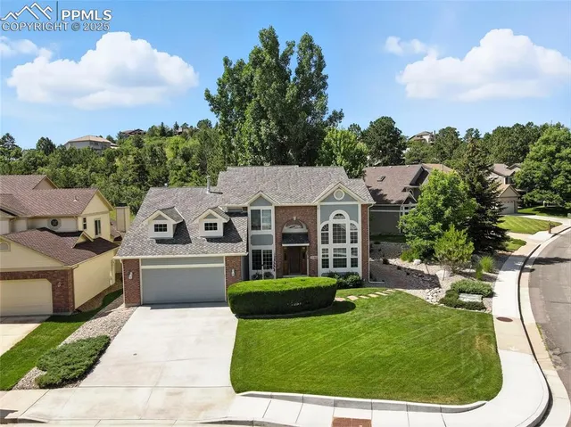 a aerial view of a house with a yard