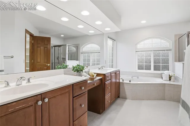 a spacious bathroom with a granite countertop tub sink and mirror
