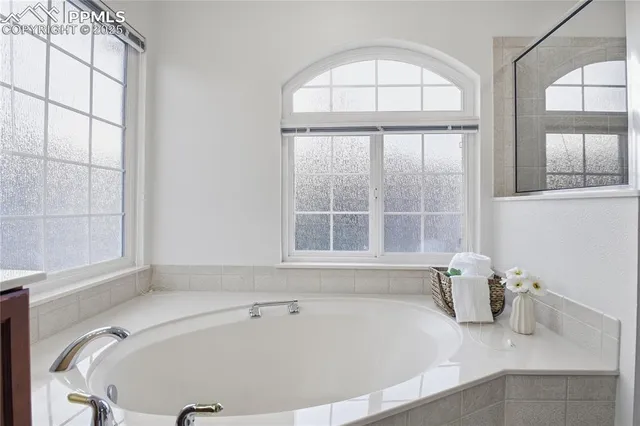 a bathroom with a bathtub and a window