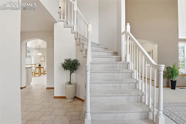 a view of staircase with white walls and stairs