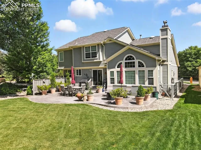 a view of a house with backyard and sitting area