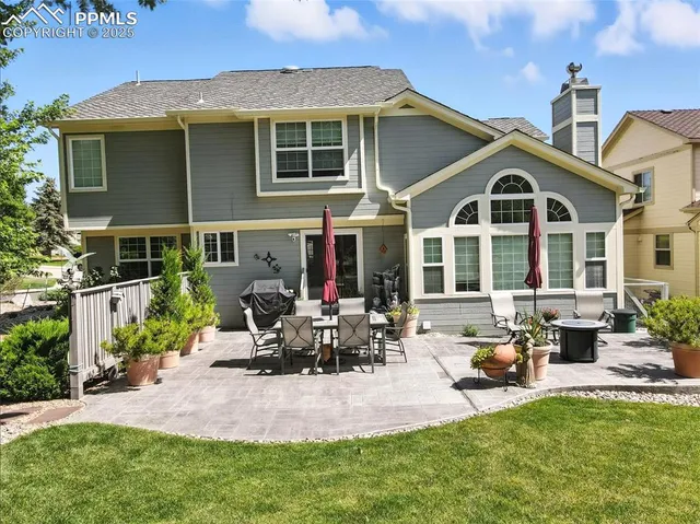 an aerial view of a house with a yard