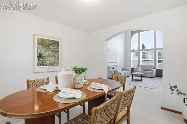 a view of a dining room with furniture and window