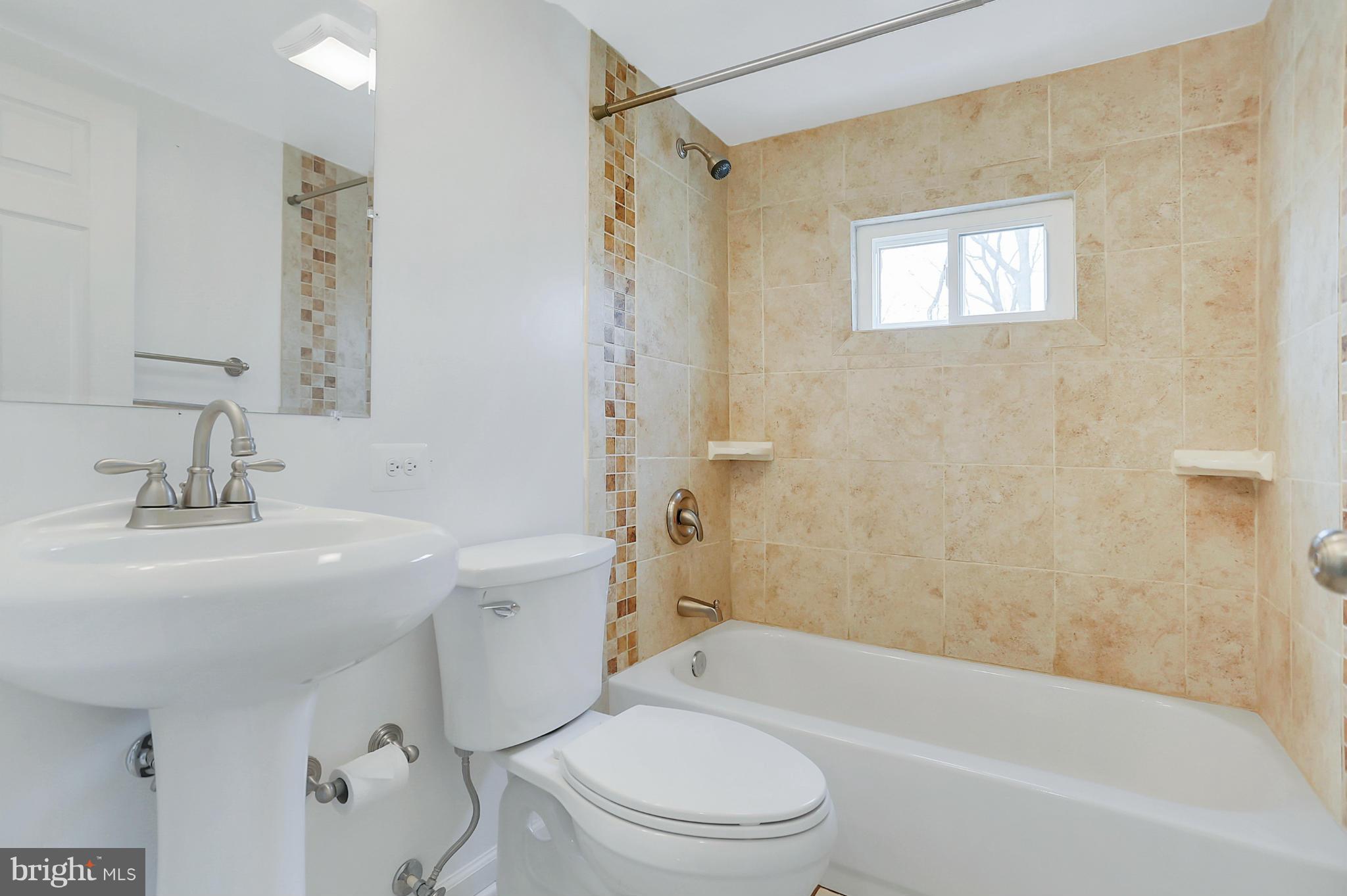 220 W Road Baltimore, MD 21221 - Photo 16 of 30 a bathroom with a sink a toilet and shower
