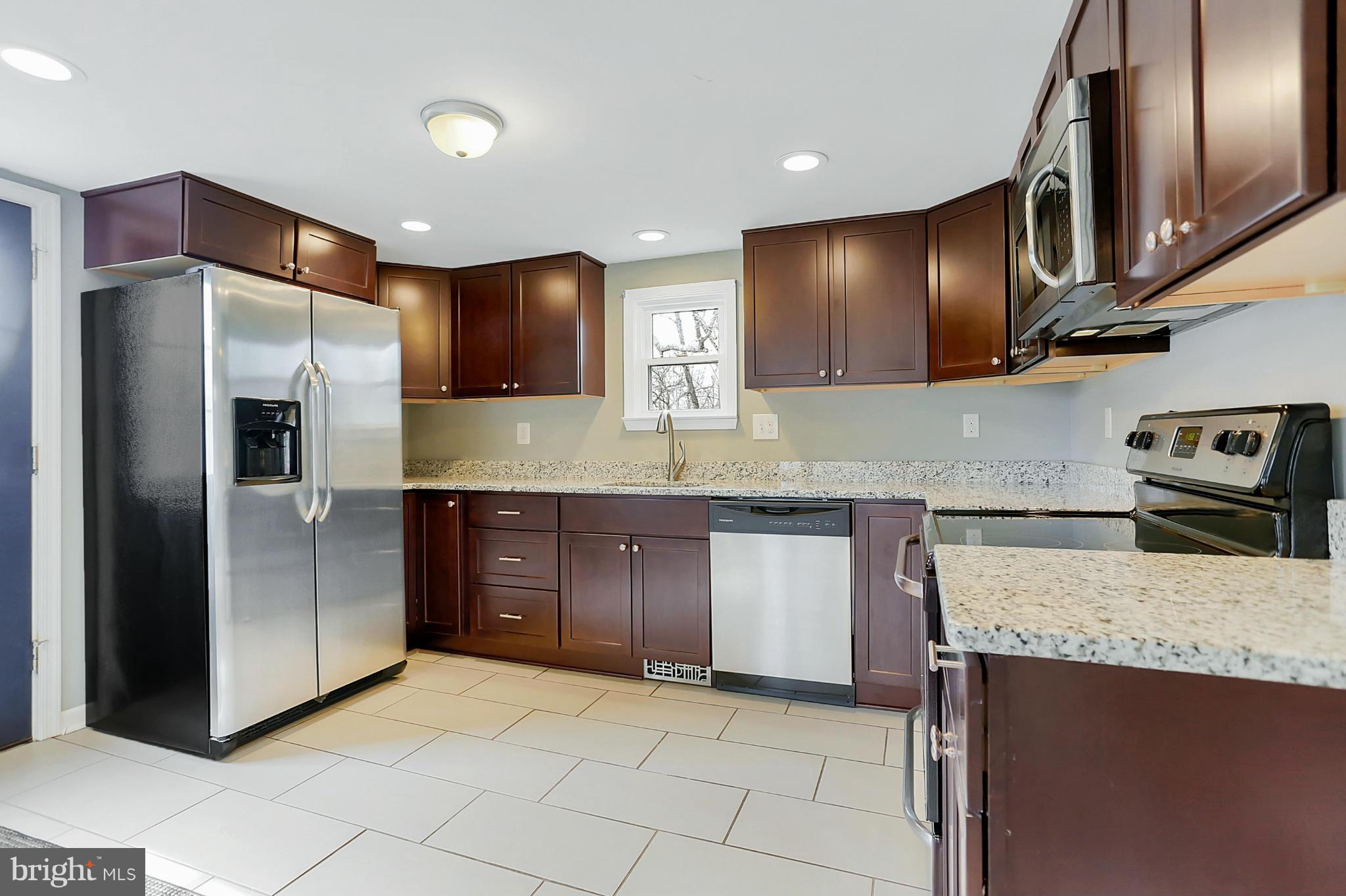 220 W Road Baltimore, MD 21221 - Photo 10 of 30 a kitchen with stainless steel appliances granite countertop a refrigerator and a sink
