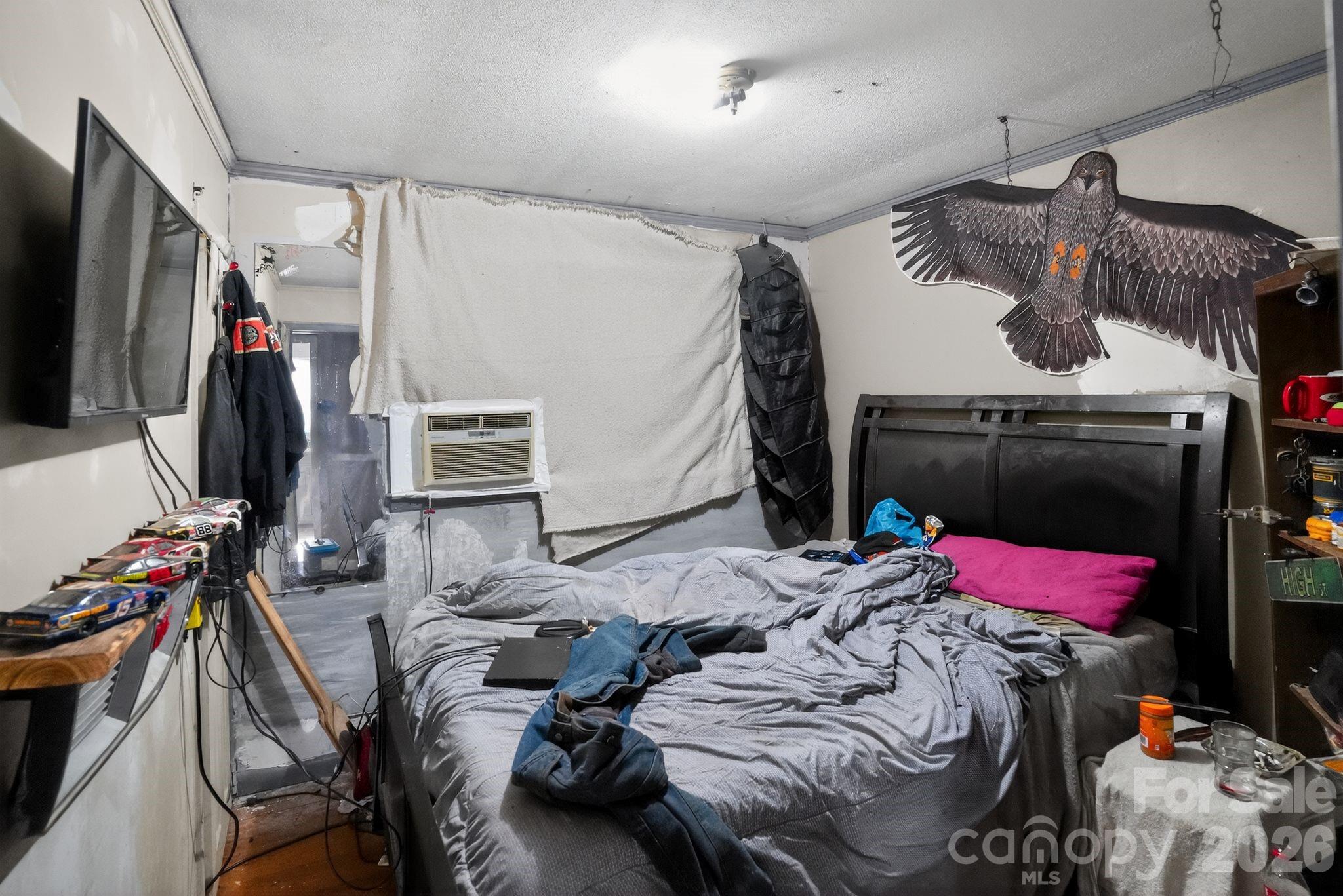 1124 Walshtown Road Boomer, NC 28606 - Photo 12 of 15 a bedroom with a bed and a flat tv screen